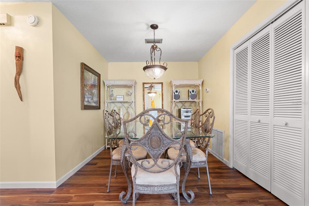 4036 Davit Drive New Port Richey, FL 34652 - Photo 19 of 64 a view of a dining room with furniture wooden floor and chandelier