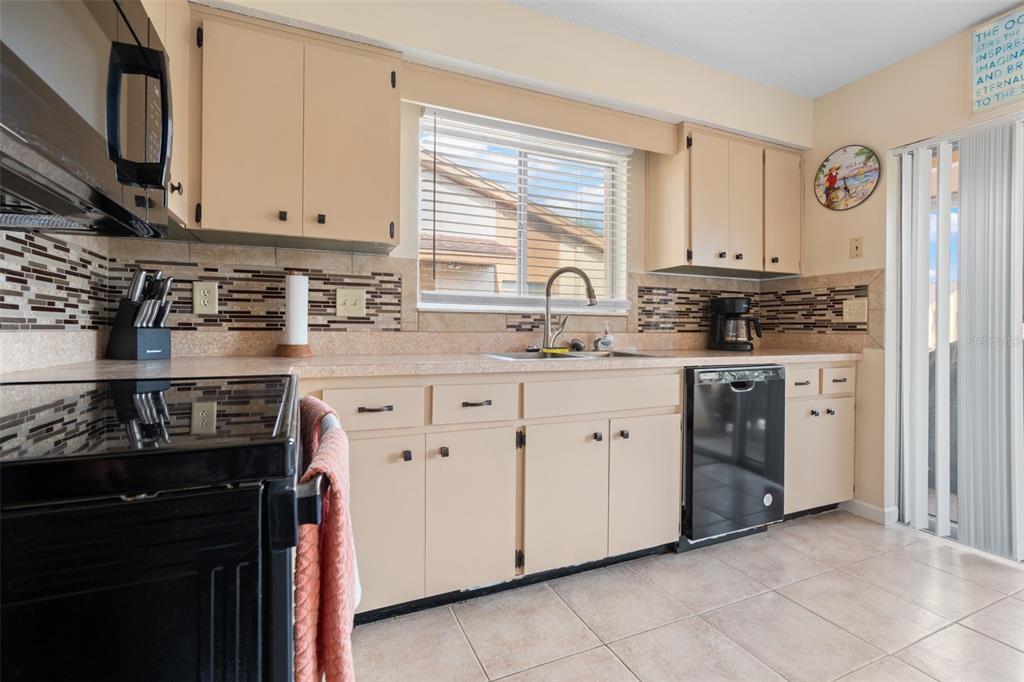 4036 Davit Drive New Port Richey, FL 34652 - Photo 23 of 64 a kitchen with stainless steel appliances granite countertop a stove sink and cabinets