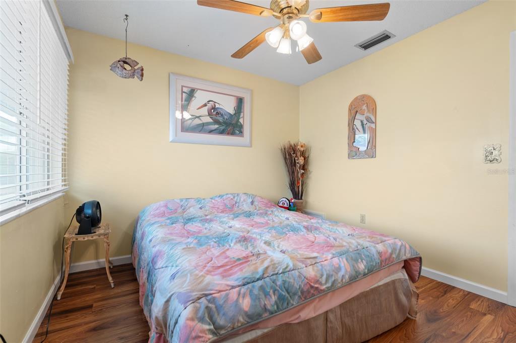 4036 Davit Drive New Port Richey, FL 34652 - Photo 39 of 64 a bedroom with a bed and a chandelier