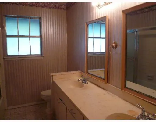 a bathroom with a sink a toilet and window