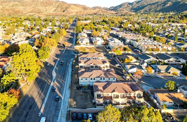 an aerial view of residential houses with outdoor space