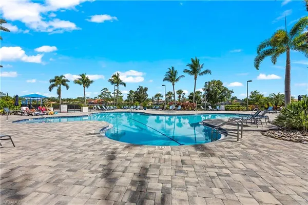 a view of swimming pool with outdoor seating and plants