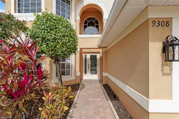 a view of a house with a door and pathway
