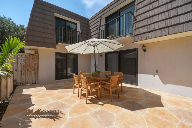a patio with a patio table and chairs