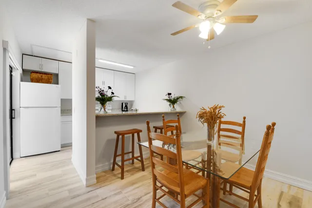 a view of a dining room with furniture and wooden floor