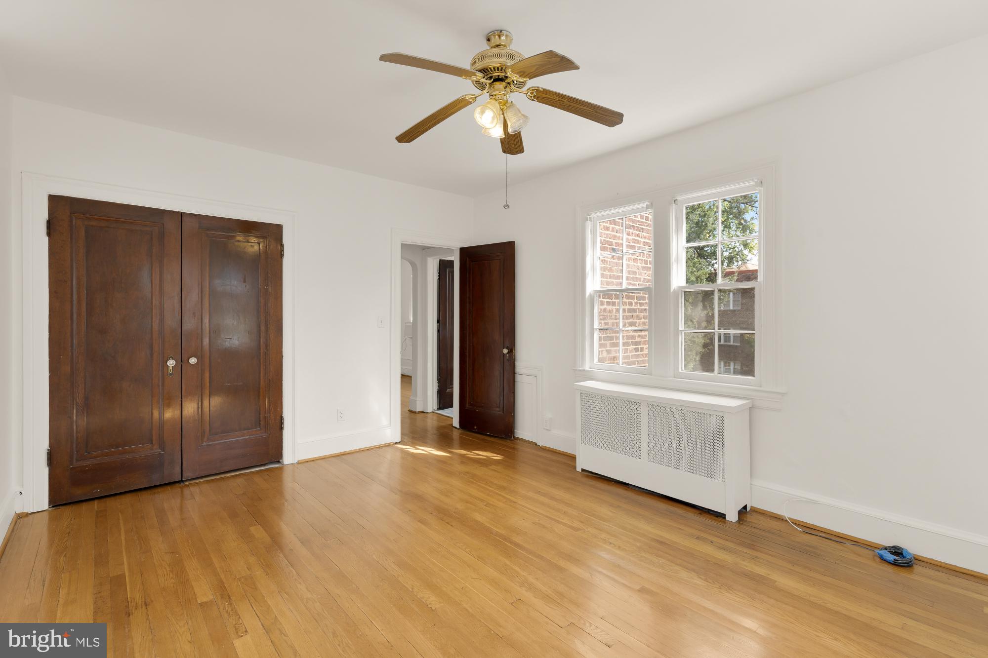 222 Farragut Street Northwest, Unit 204 Washington, DC 20011 - Photo 12 of 14 wooden floor in an empty room with a window