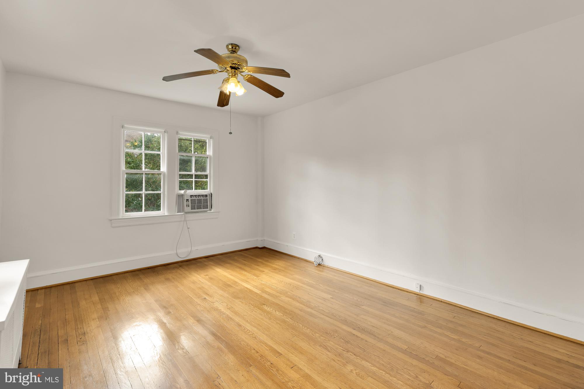 222 Farragut Street Northwest, Unit 204 Washington, DC 20011 - Photo 13 of 14 a view of an empty room with wooden floor and a window
