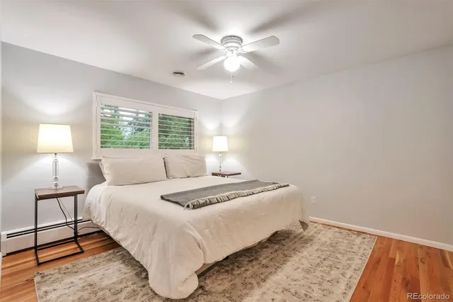 a bedroom with a bed and a night stand