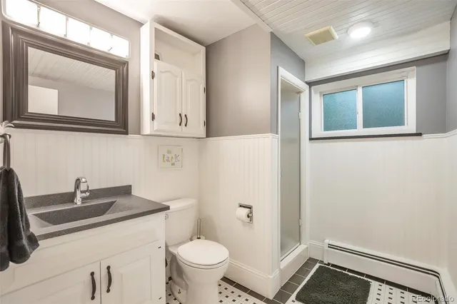 a bathroom with a sink toilet and mirror