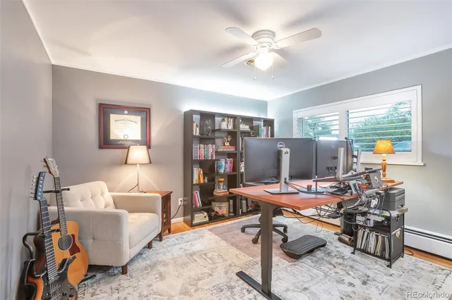 a view of a livingroom with workspace and a window
