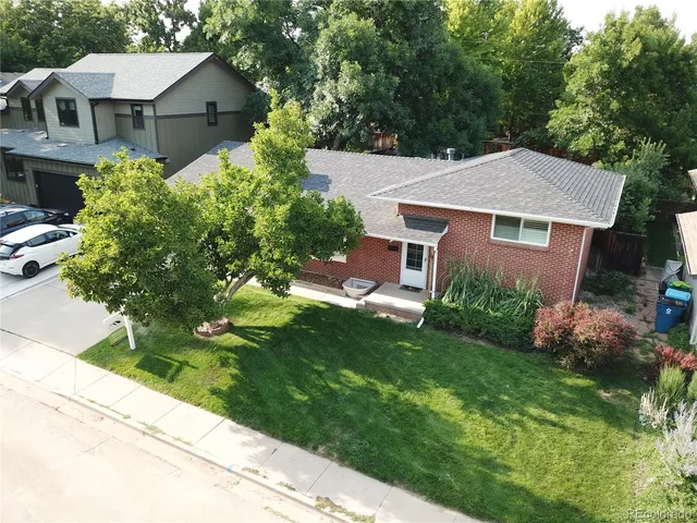 a aerial view of a house with a yard and potted plants