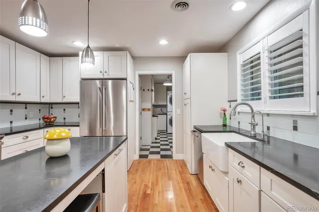 a kitchen with a refrigerator and a sink