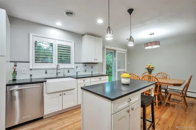 a kitchen with a sink window and cabinets