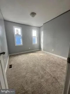 an empty room with windows and closet
