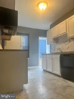 a view of staircase with railing and white walls