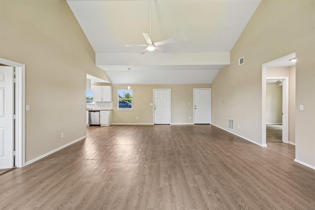 433 Whitney Court Rio Vista, TX 76093 - Photo 7 of 27 an empty room with wooden floor and windows