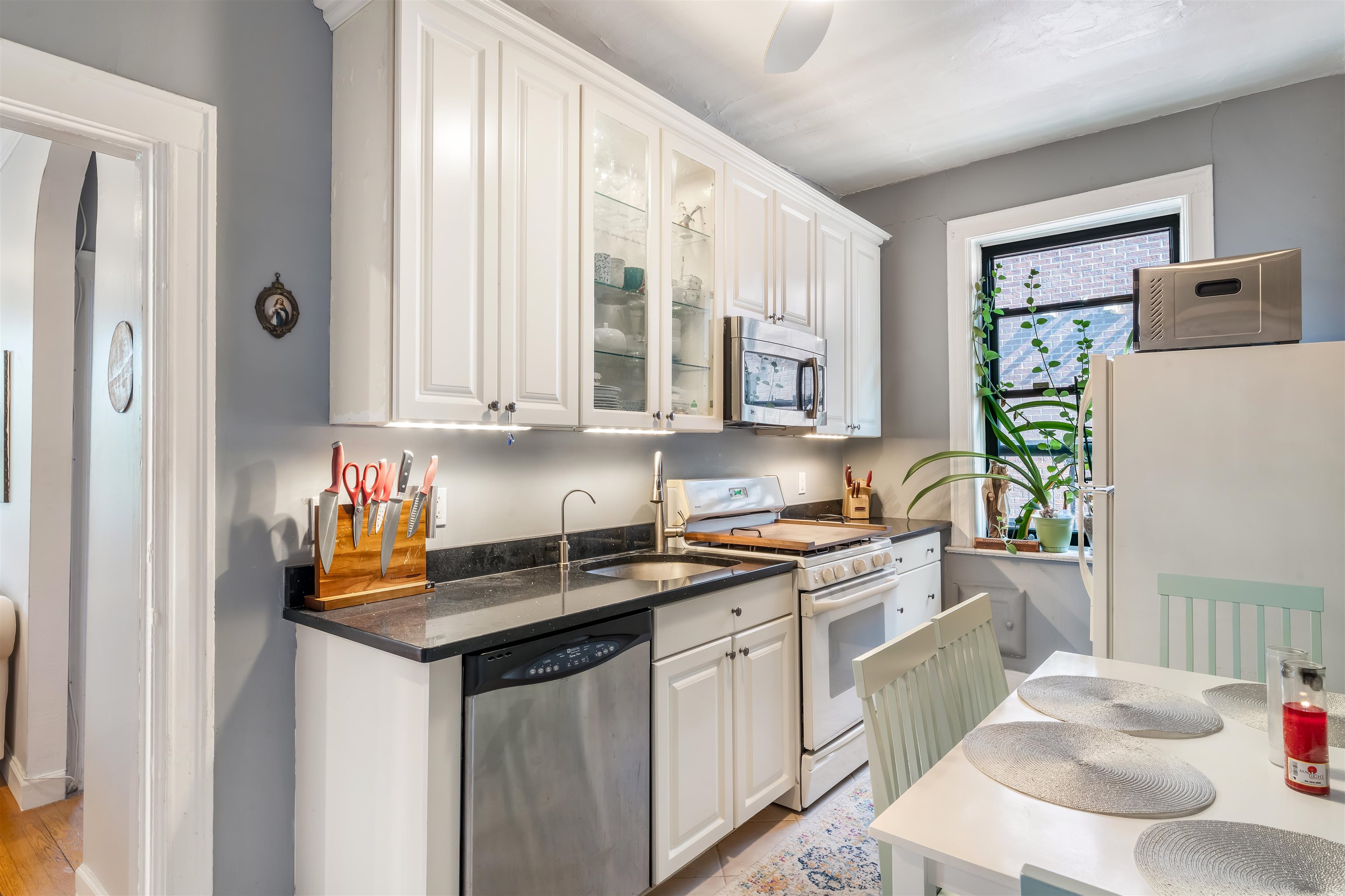 150 37th Street, Unit D4 Union City, NJ 07087 - Photo 4 of 22 a kitchen with stainless steel appliances a sink a stove a refrigerator and cabinets