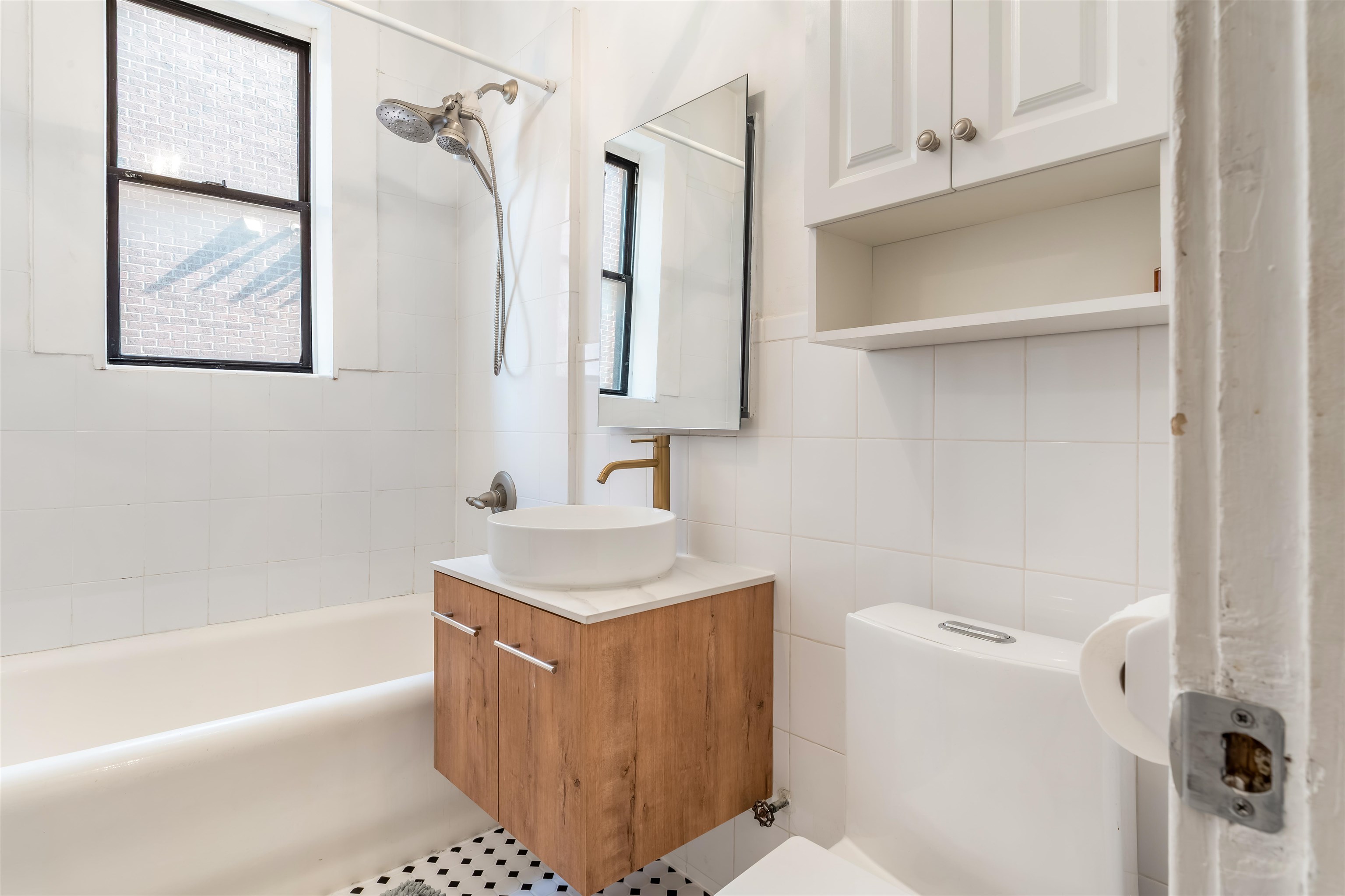 150 37th Street, Unit D4 Union City, NJ 07087 - Photo 7 of 22 a bathroom with a sink a toilet and shower