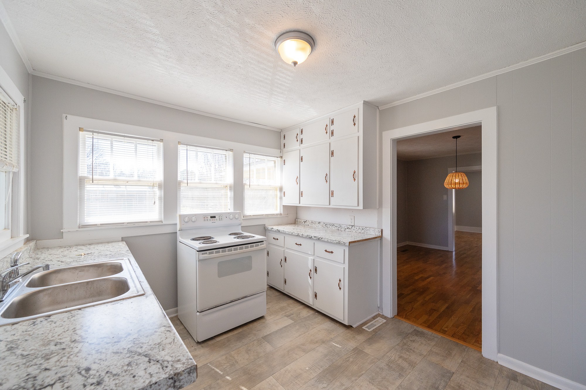 1213 Perryville Road Parsons, TN 38363 - Photo 15 of 32 a kitchen with a stove a sink and a refrigerator