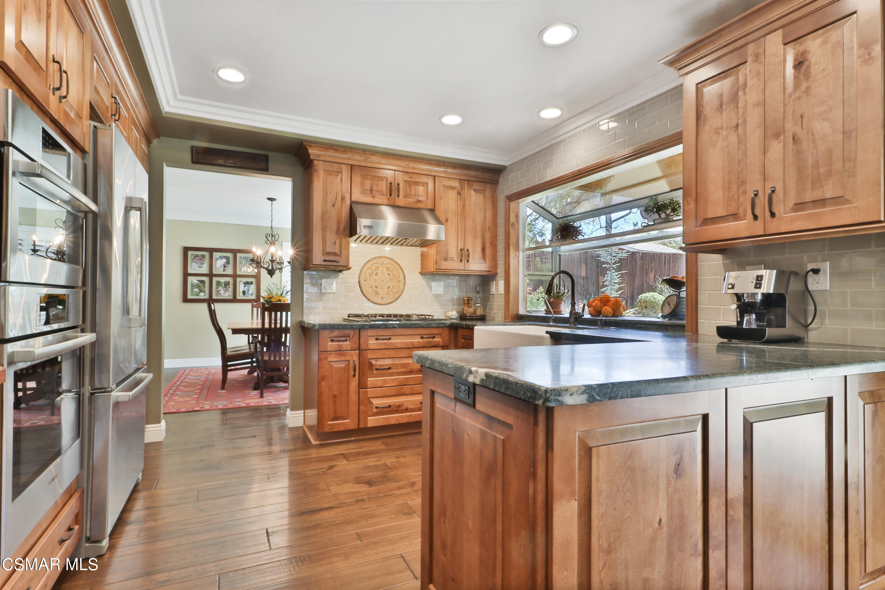 243 Longbranch Road Simi Valley, CA 93065 - Photo 23 of 77 a kitchen with lots of counter top space and wooden floor