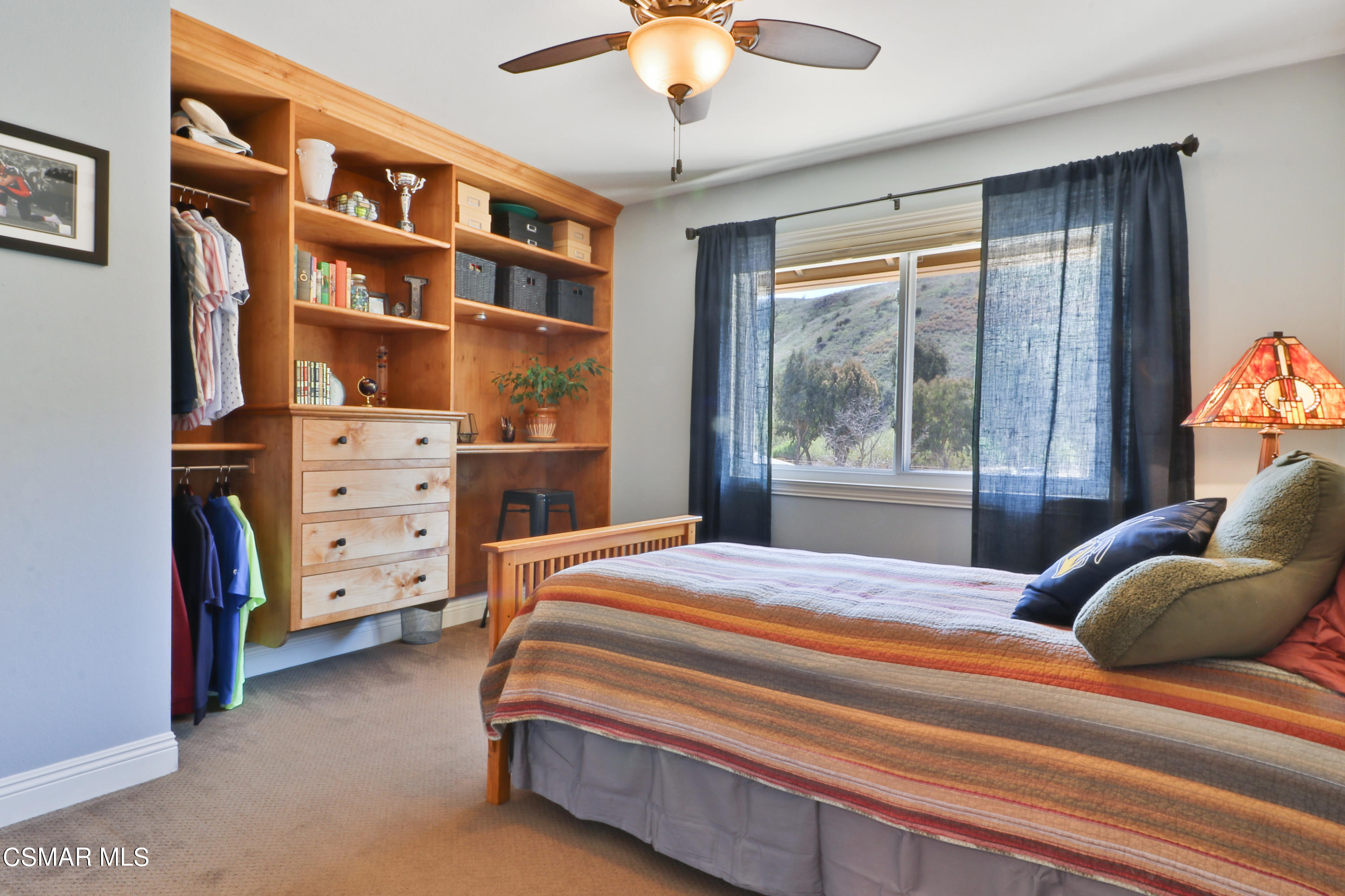 243 Longbranch Road Simi Valley, CA 93065 - Photo 35 of 77 a bedroom with a bed and a chandelier