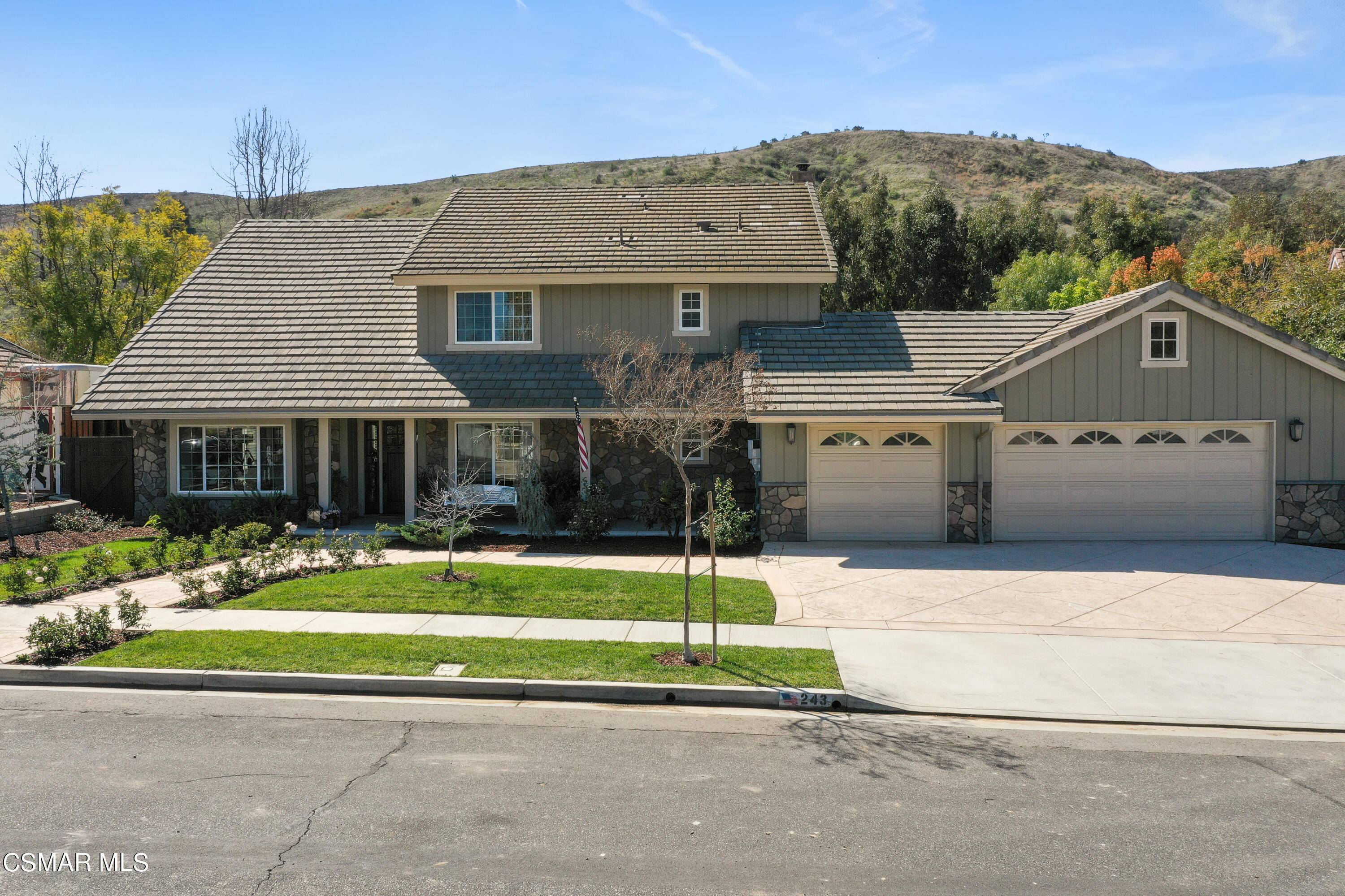 243 Longbranch Road Simi Valley, CA 93065 - Photo 5 of 77 a front view of a house with a yard and garage