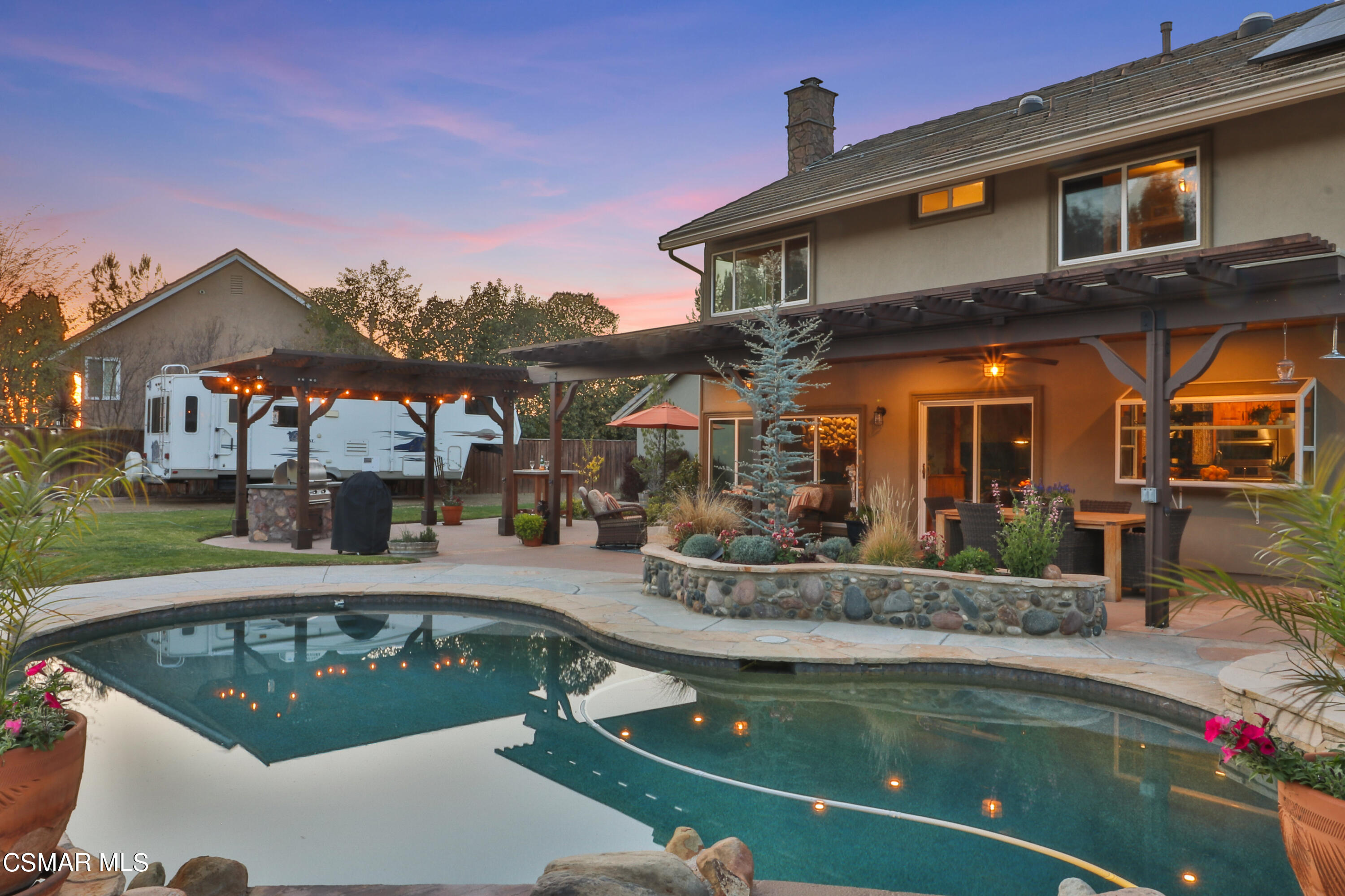 243 Longbranch Road Simi Valley, CA 93065 - Photo 56 of 77 a view of a patio with couches table and chairs with potted plants