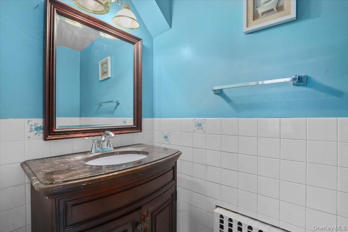 74 White Road Scarsdale, NY 10583 - Photo 11 of 27 a bathroom with a sink and a mirror