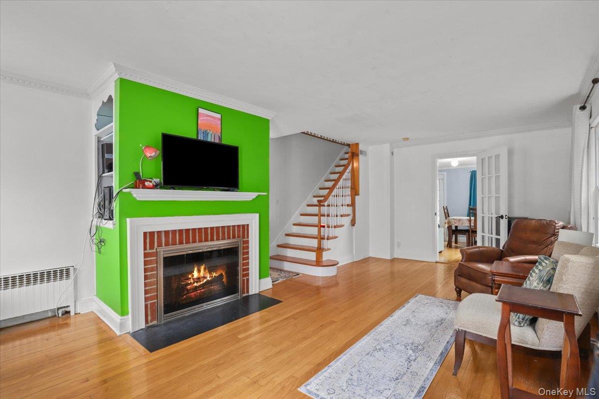 74 White Road Scarsdale, NY 10583 - Photo 14 of 27 a living room with furniture a flat screen tv and a fireplace