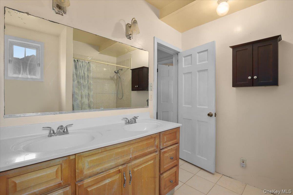 74 White Road Scarsdale, NY 10583 - Photo 18 of 27 a bathroom with a sink and a mirror