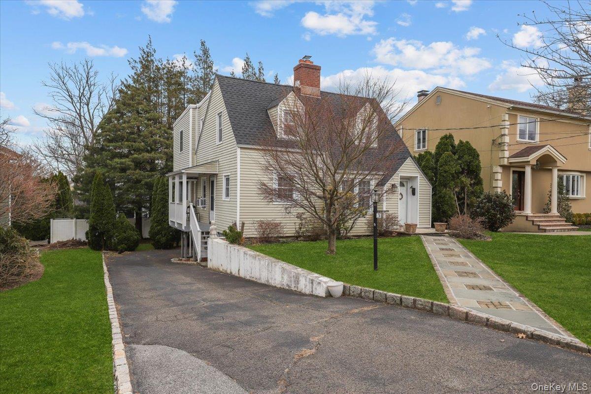74 White Road Scarsdale, NY 10583 - Photo 2 of 27 a view of a white house next to a yard with big trees
