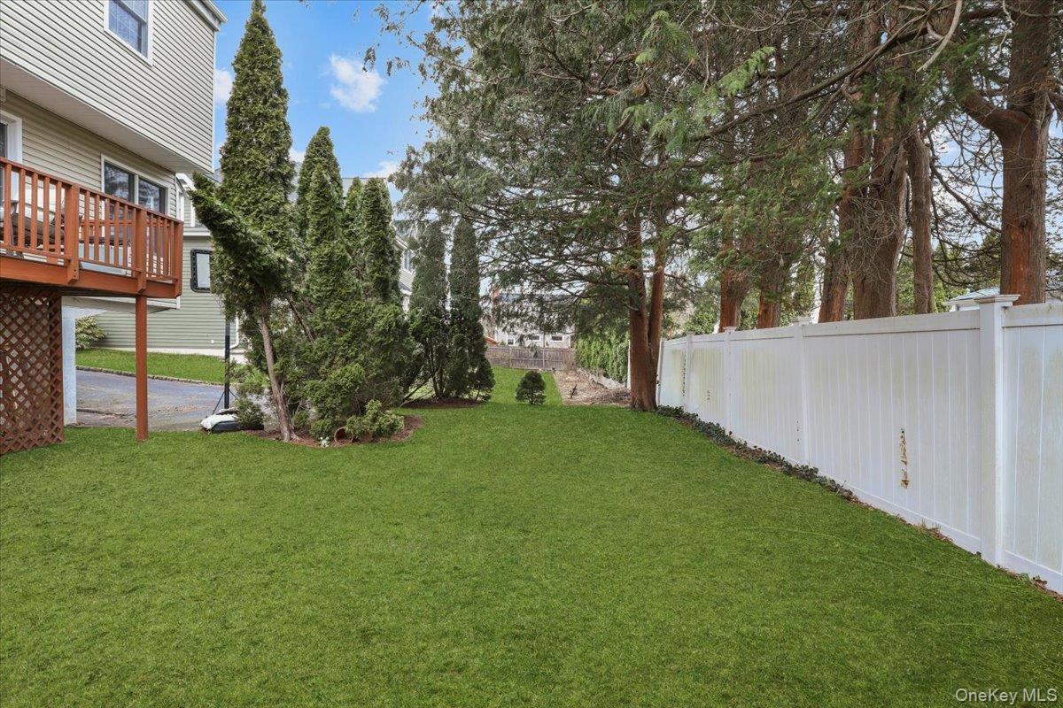 74 White Road Scarsdale, NY 10583 - Photo 23 of 27 a view of a backyard with large trees