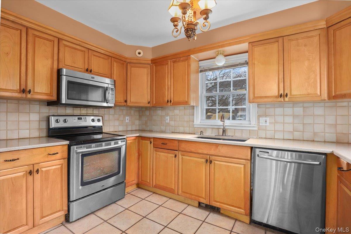 74 White Road Scarsdale, NY 10583 - Photo 5 of 27 a kitchen with granite countertop cabinets stainless steel appliances and a sink