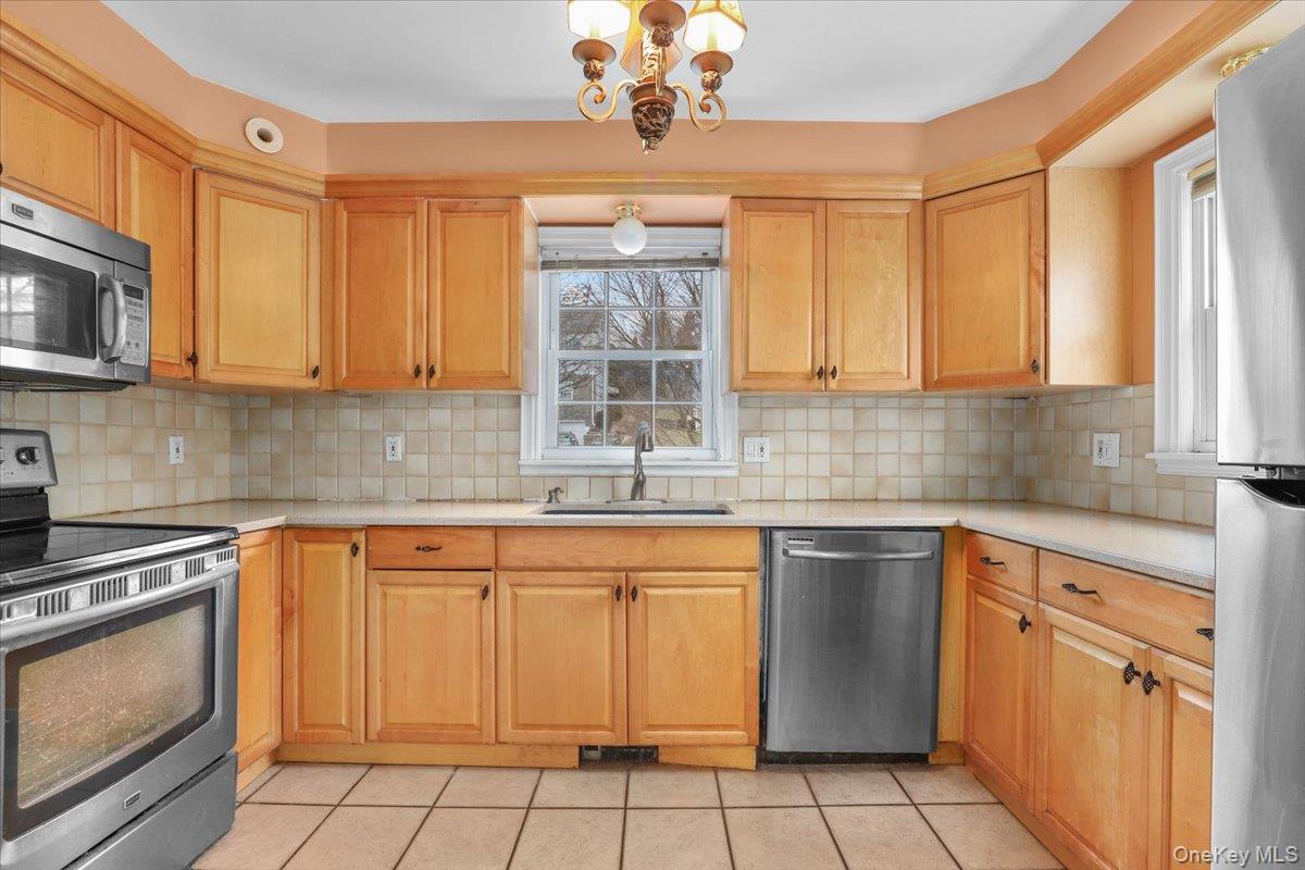 74 White Road Scarsdale, NY 10583 - Photo 6 of 27 a kitchen with stainless steel appliances granite countertop a sink a stove and cabinets