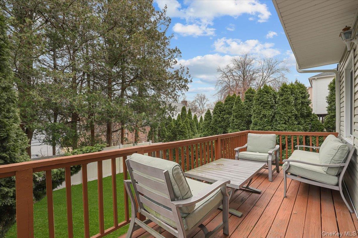 74 White Road Scarsdale, NY 10583 - Photo 8 of 27 a balcony with wooden benches