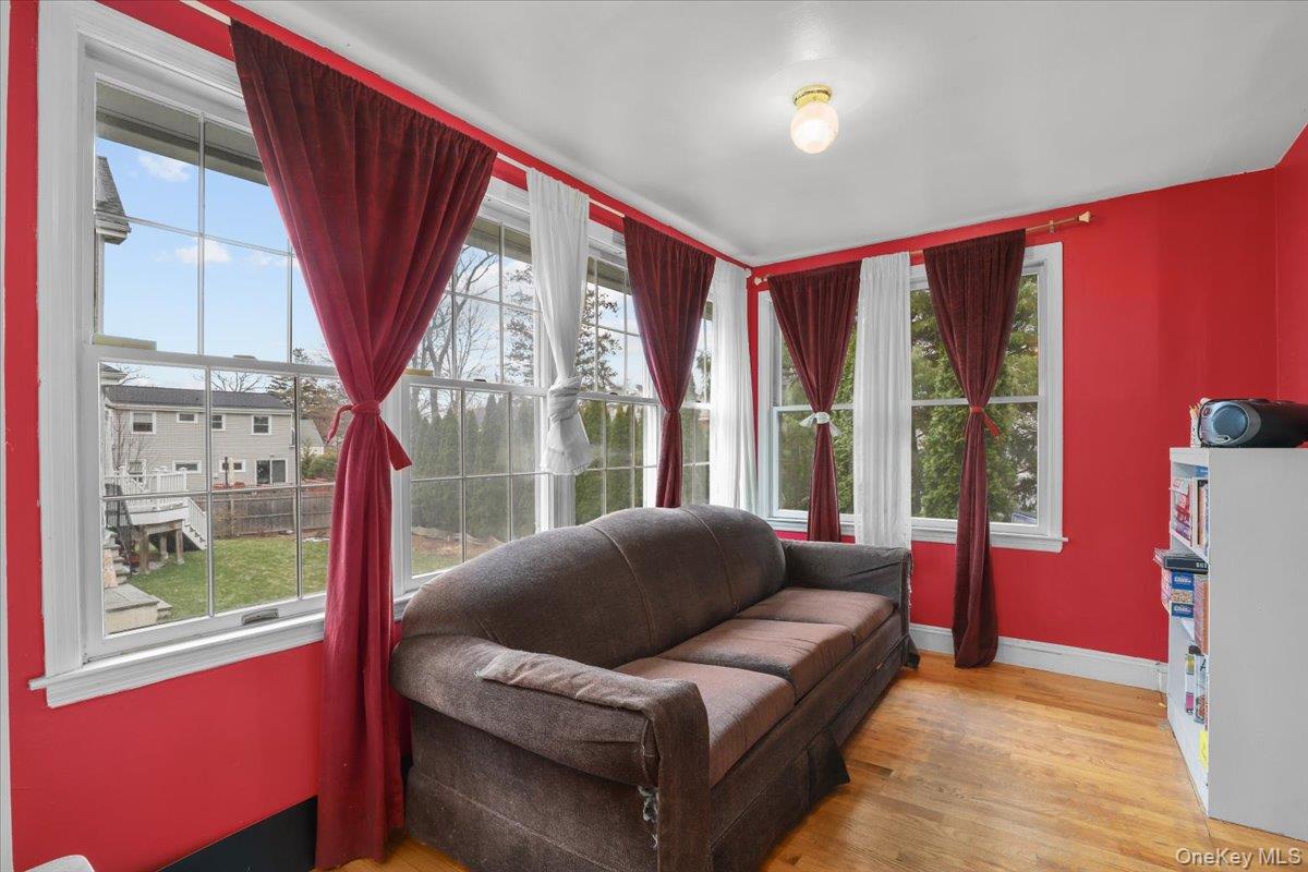 74 White Road Scarsdale, NY 10583 - Photo 10 of 27 a living room with furniture a large window with wooden floor