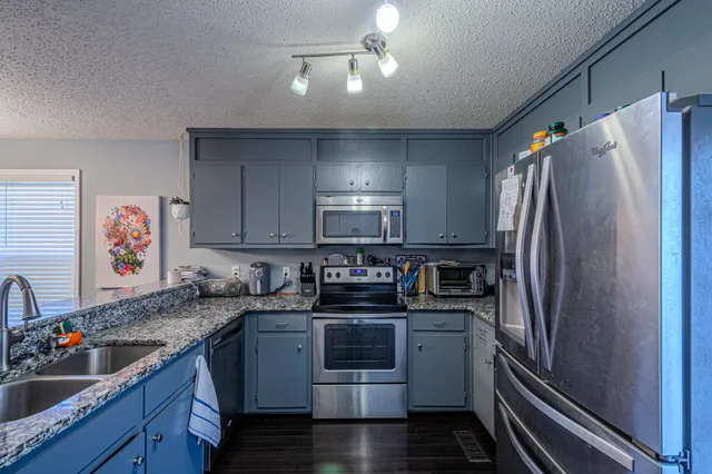 a view of washer and dryer with kitchen in the background
