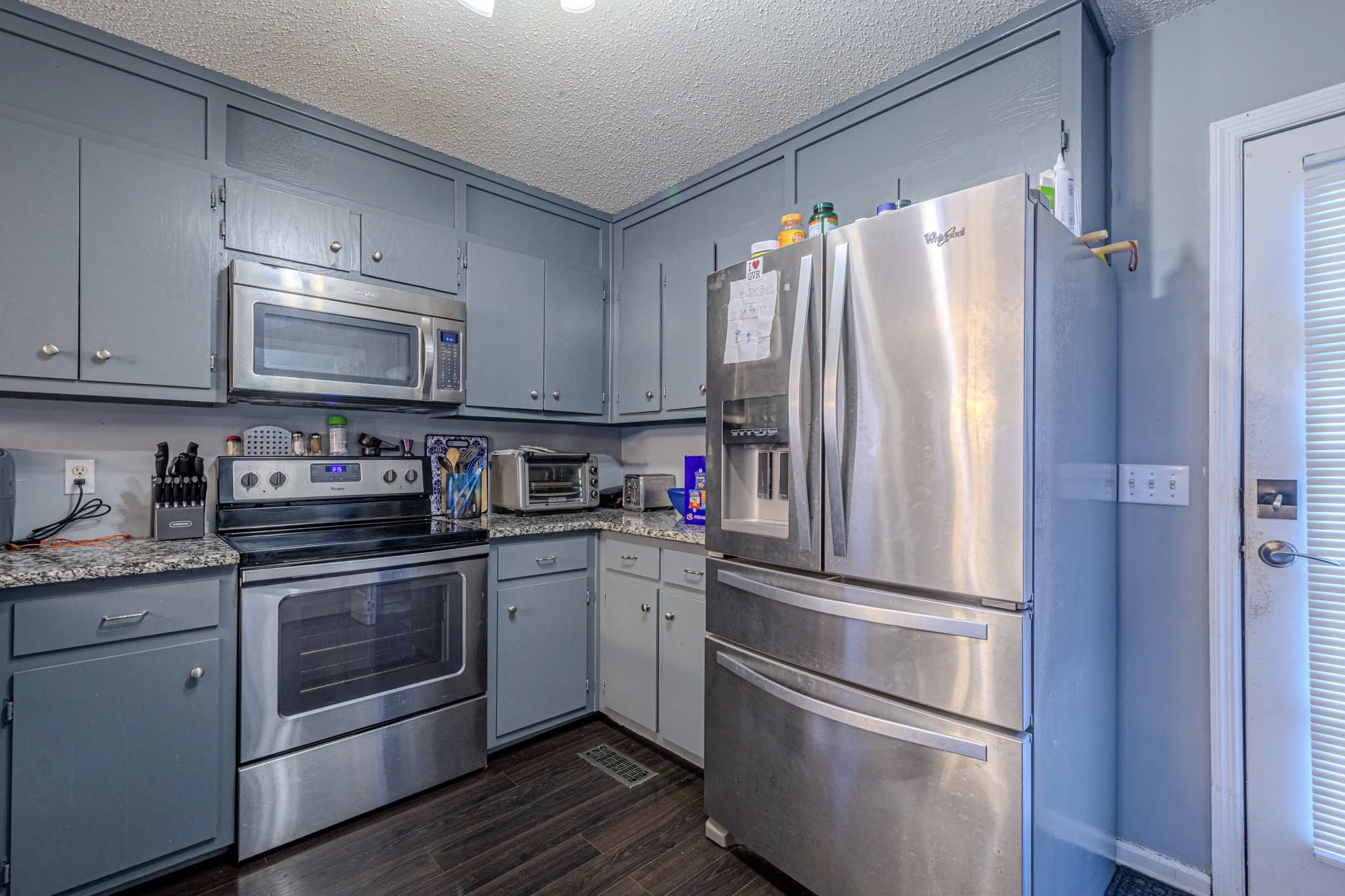 25230 Union Hill Road Ardmore, TN 38449 - Photo 48 of 55 a kitchen with stainless steel appliances granite countertop a refrigerator and a stove top oven
