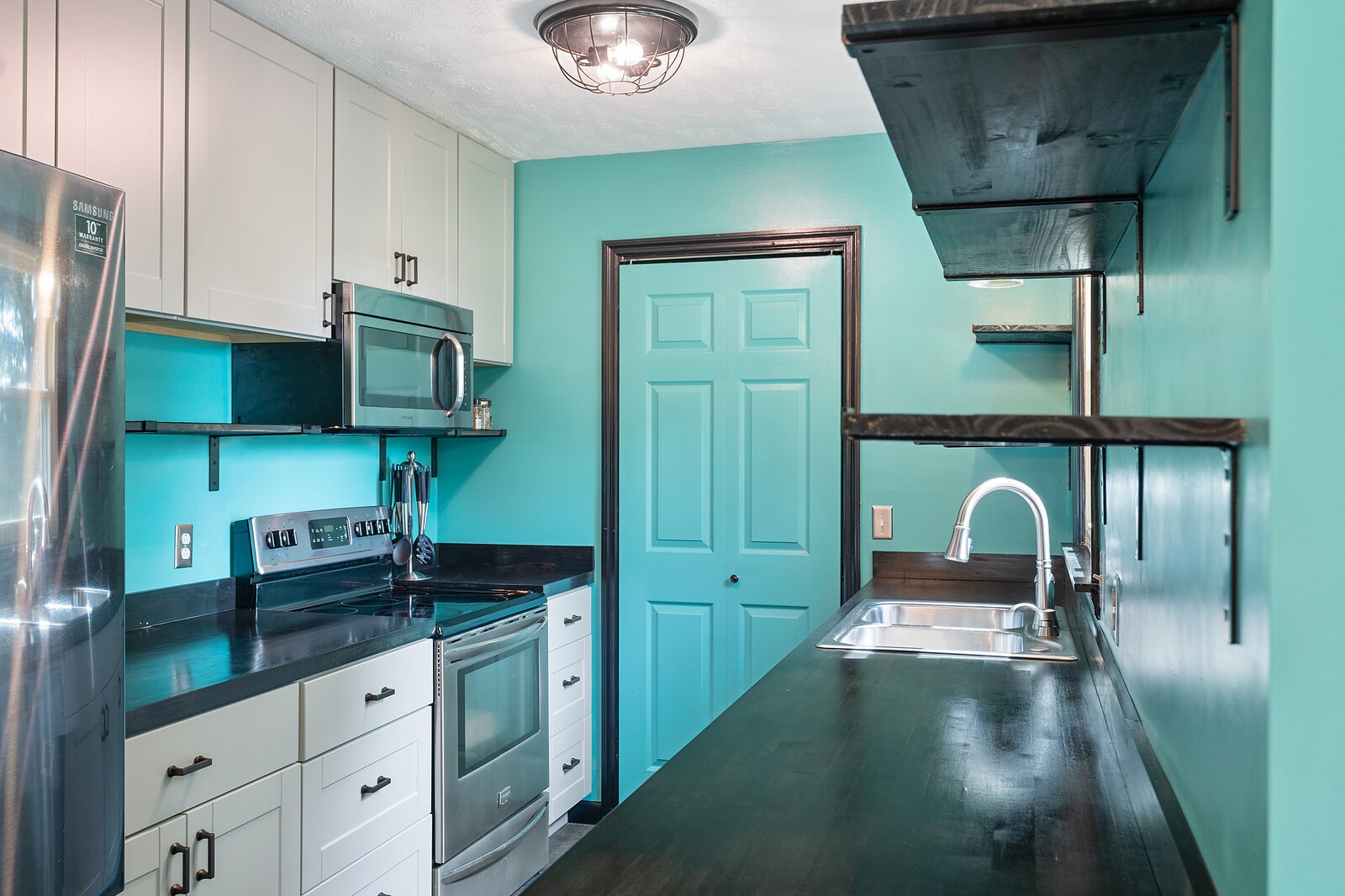 6658 Highway 49 Springfield, TN 37172 - Photo 12 of 44 a kitchen with stainless steel appliances granite countertop a sink a stove and cabinets