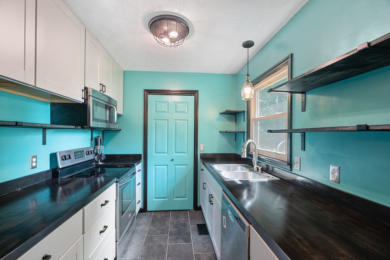 6658 Highway 49 Springfield, TN 37172 - Photo 13 of 44 a kitchen with stainless steel appliances granite countertop a sink a stove and a refrigerator