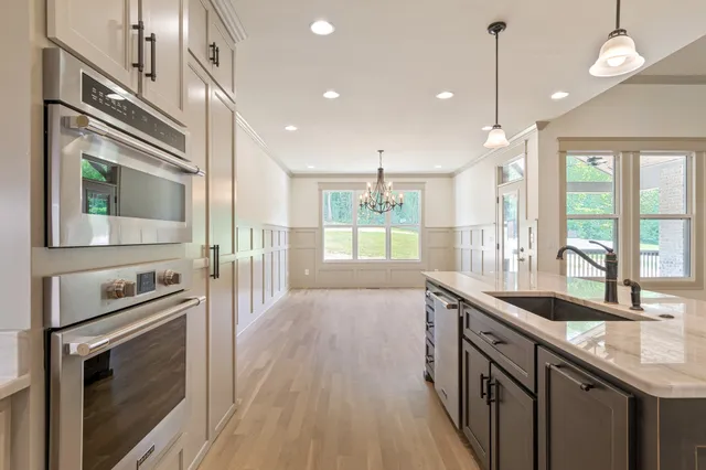 a view of an empty room with a window and a ceiling fan