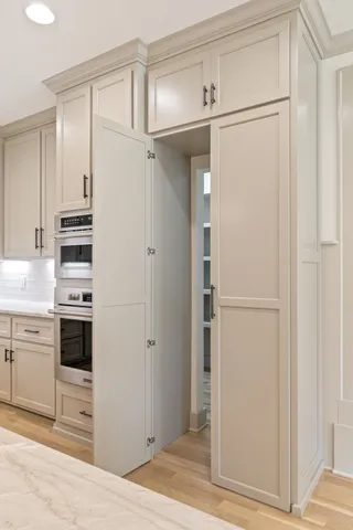a view of a livingroom with wooden floor and a ceiling fan