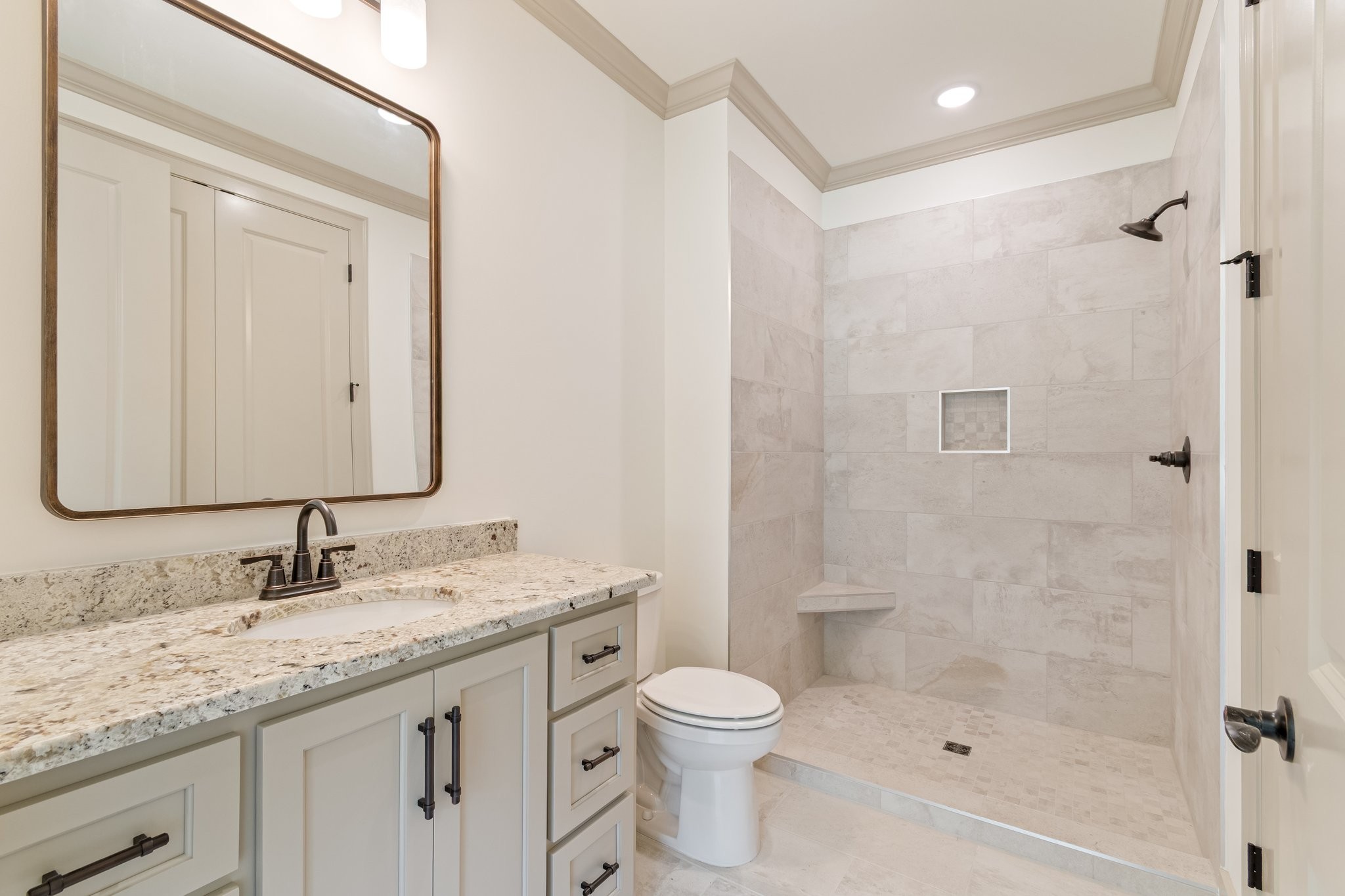4100 Affiant Way Culleoka, TN 38451 - Photo 21 of 27 a bathroom with a granite countertop sink a toilet and shower