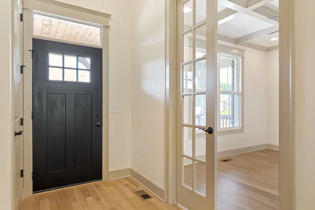 wooden floor fireplace and windows in an empty room