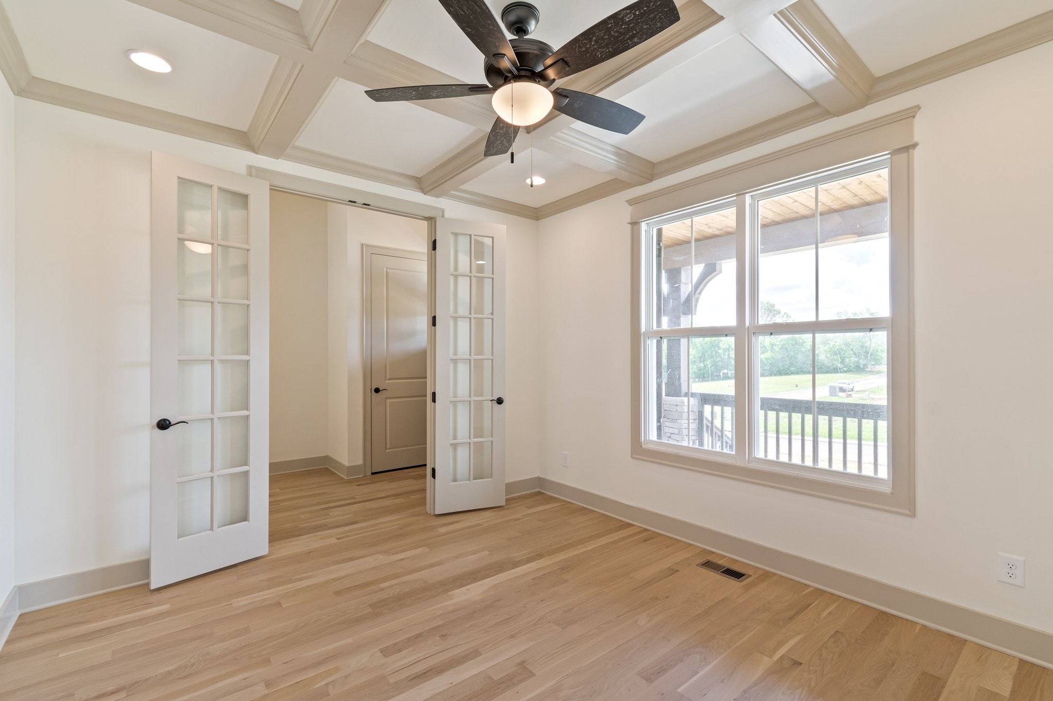4100 Affiant Way Culleoka, TN 38451 - Photo 5 of 27 a view of an empty room with wooden floor and a window