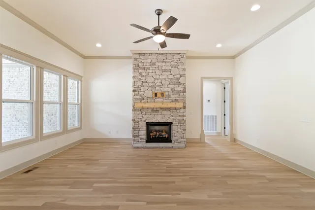 a kitchen with a sink stove and wooden floor