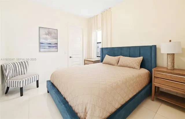 a bedroom with a bed and chair