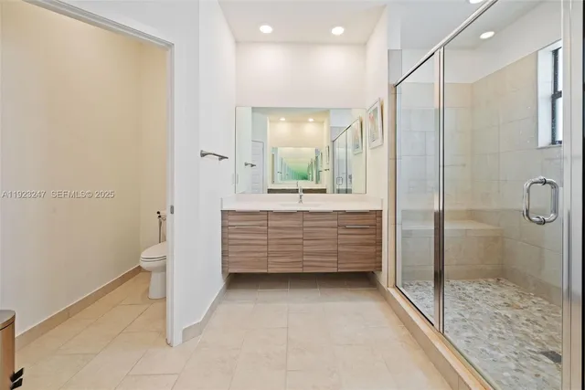a bathroom with a mirror a bathtub and a shower