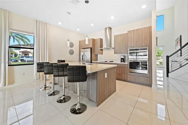 a kitchen with stainless steel appliances kitchen island granite countertop a sink and cabinets