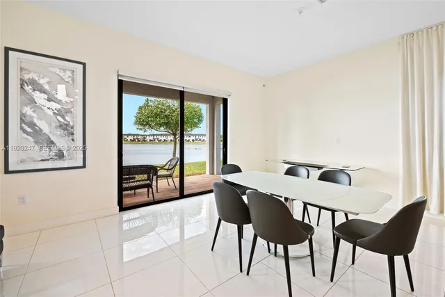 a view of a dining room with furniture and a large window